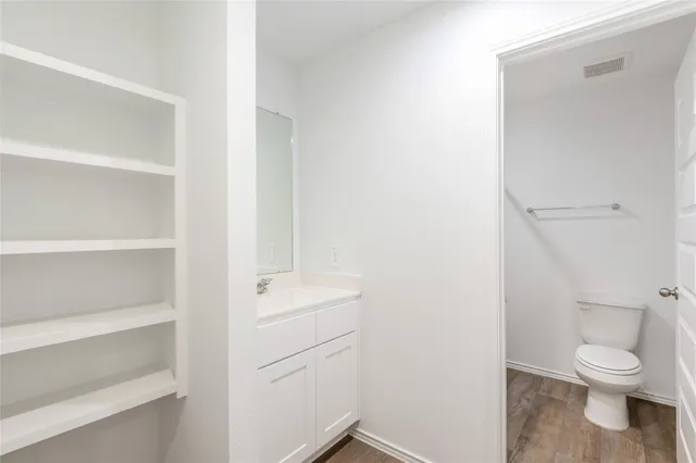 a white toilet sitting next to a bathroom sink