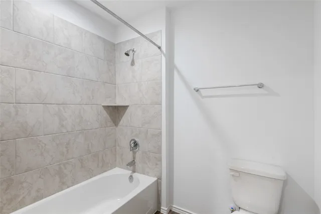 a bathroom with a bathtub and a toilet