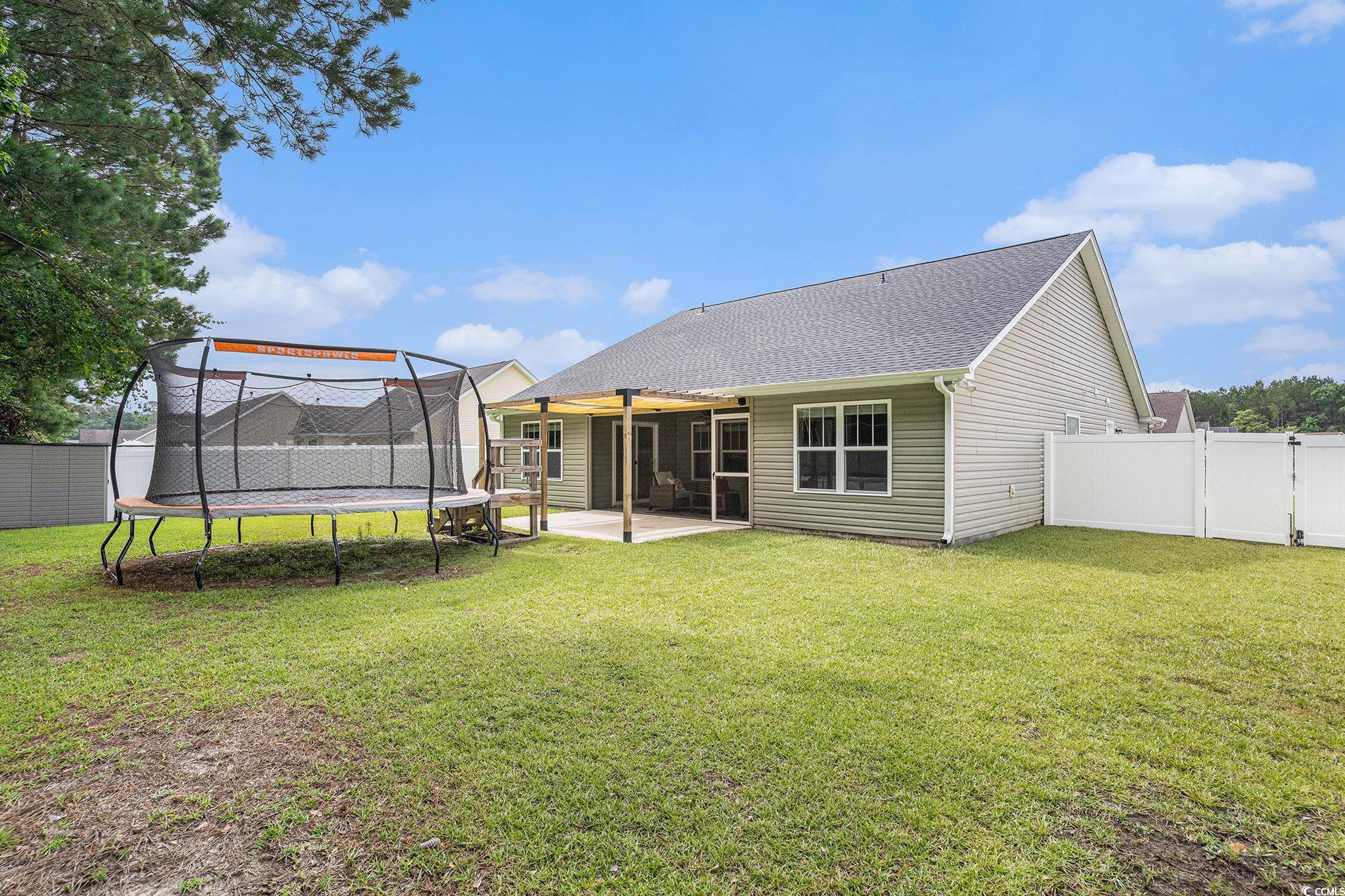 276 Avery Drive Myrtle Beach, SC 29588 - Photo 24 of 26 Rear view of property featuring a trampoline, a pa