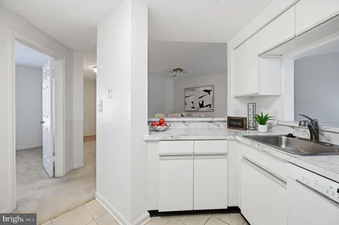 a utility room with cabinets washer and dryer