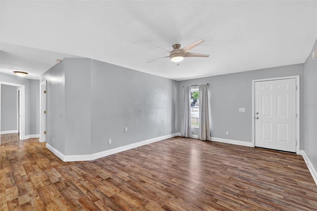 36 Bay Ridge Loop Mascotte, FL 34753 - Photo 8 of 32 a view of an empty room with wooden floor