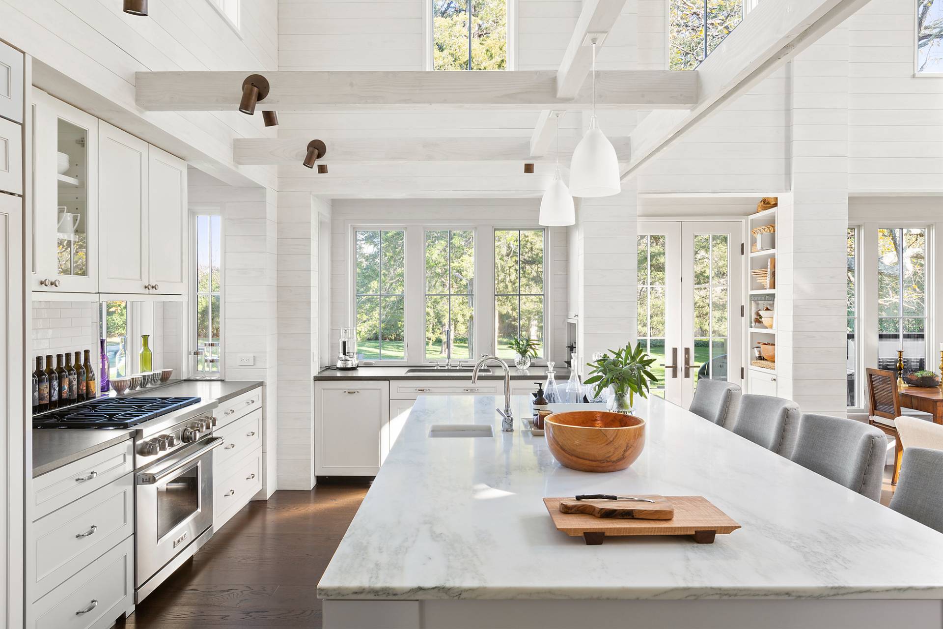 467 Further Lane Amagansett, NY 11930 - Photo 9 of 23 a kitchen with a stove a sink a dining table and chairs