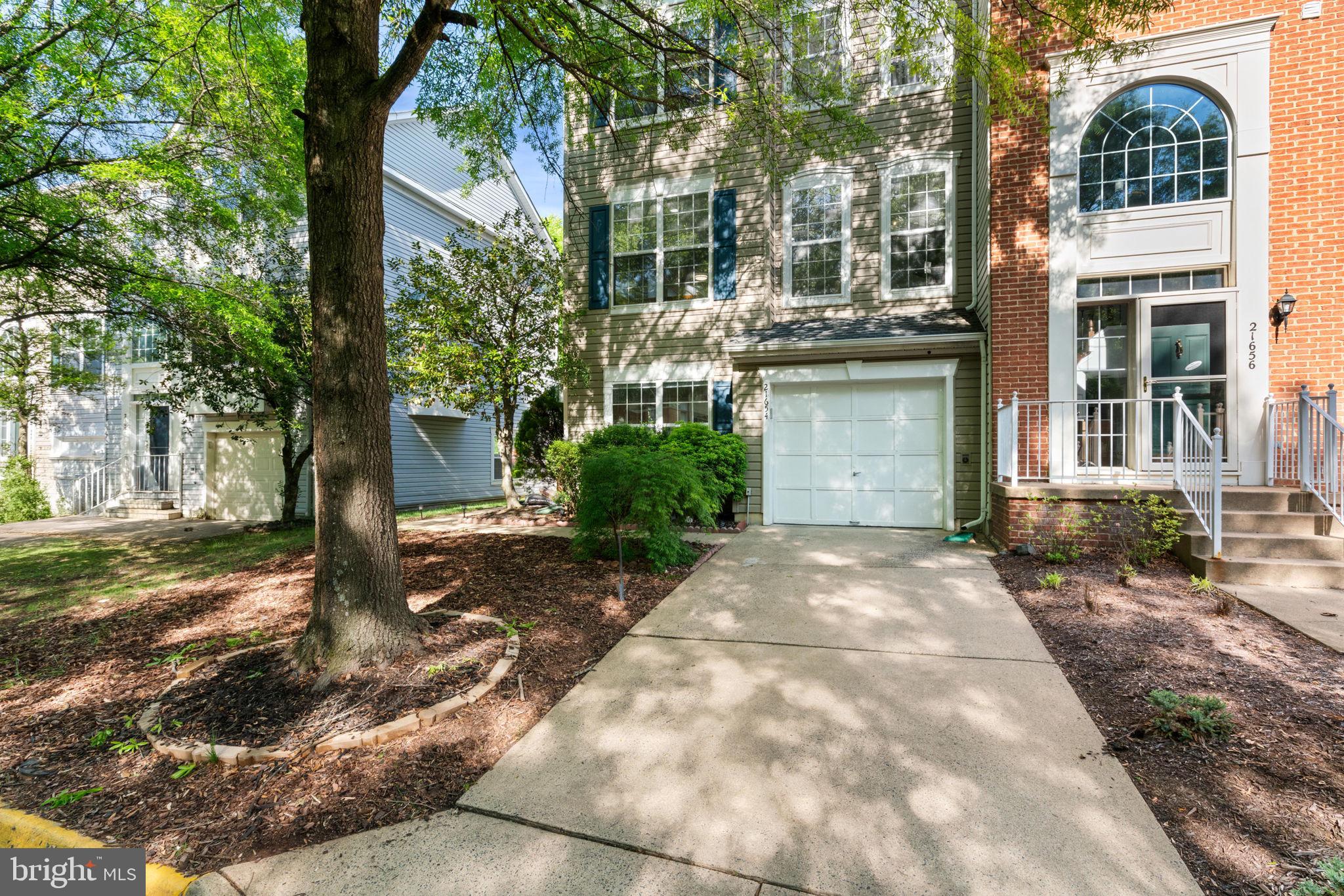21654 Frame Square Broadlands, VA 20148 - Photo 4 of 43 Charming facade with lush greenery.