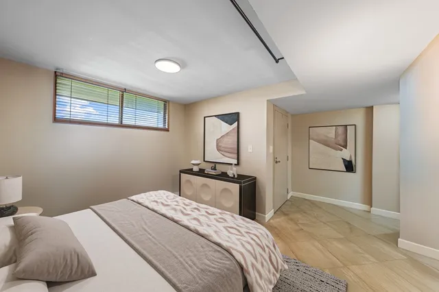 a bedroom with a bed and dresser