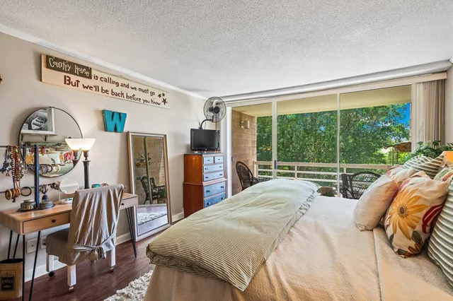 a bedroom with a bed and a large window