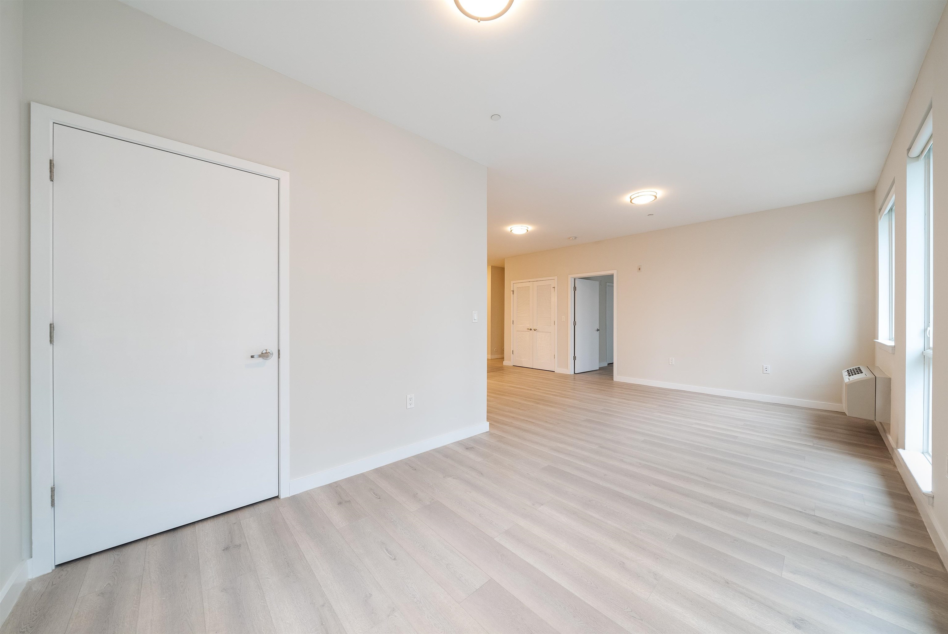 16 Bennett Street, Unit 504 Jersey City, NJ 07304 - Photo 10 of 24 a view of an empty room with wooden floor and closet