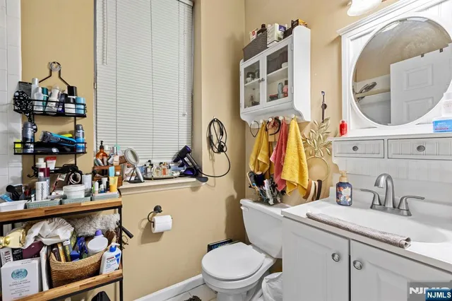 a bathroom with a toilet sink and mirror