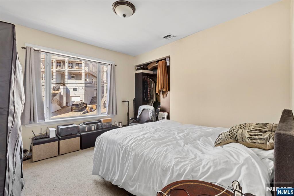 67 Highway 5 Edgewater, NJ 07020 - Photo 20 of 24 a bedroom with a bed and wooden floor