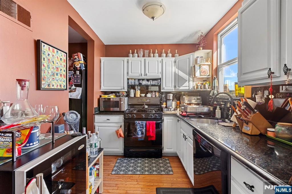 67 Highway 5 Edgewater, NJ 07020 - Photo 2 of 24 a kitchen with stainless steel appliances granite countertop a stove a sink and a microwave