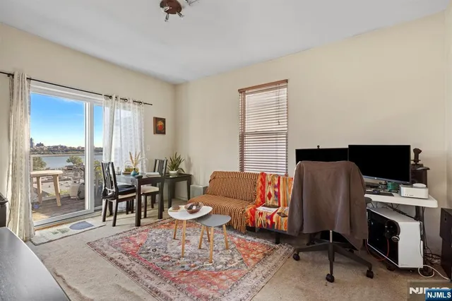 a living room with furniture rug and a window