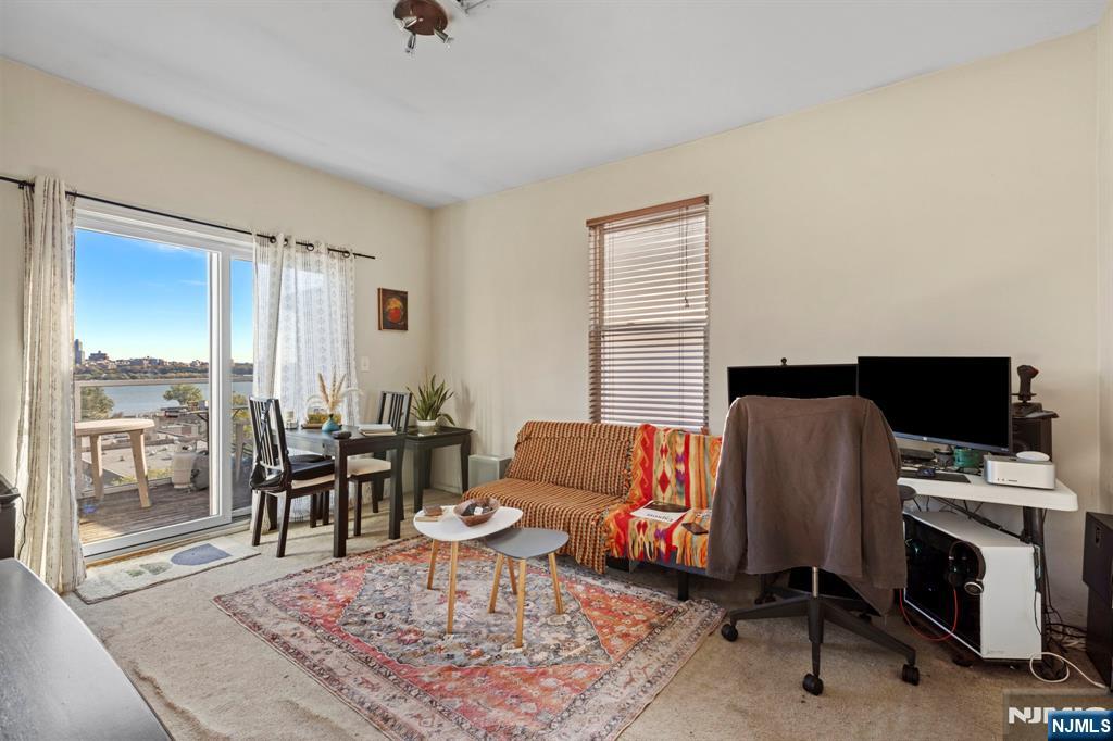 67 Highway 5 Edgewater, NJ 07020 - Photo 21 of 24 a living room with furniture rug and a window