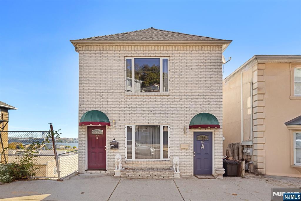 67 Highway 5 Edgewater, NJ 07020 - Photo 23 of 24 a front view of a house with garage