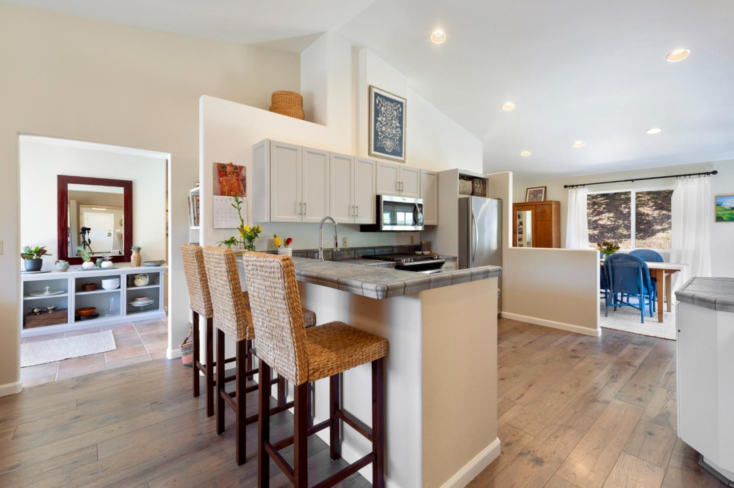 481 Maher Road Watsonville, CA 95076 - Photo 12 of 34 a kitchen with stainless steel appliances kitchen island granite countertop a table chairs and a refrigerator