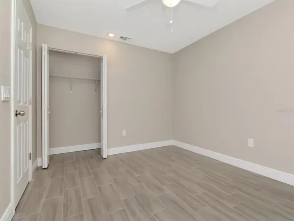 a view of an empty room with wooden floor