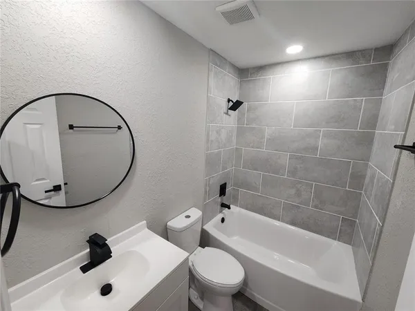 a white toilet sitting next to a bathroom sink