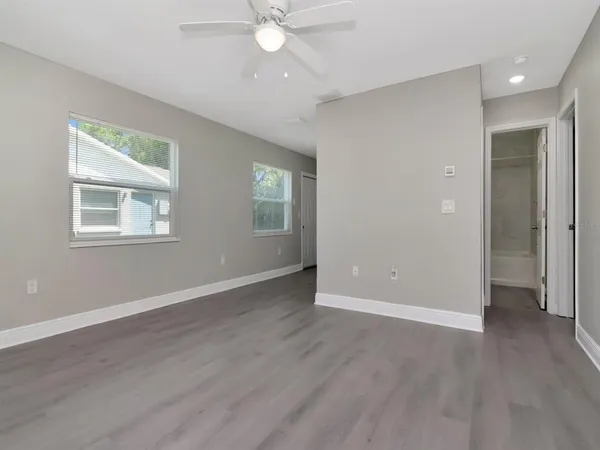 a view of an empty room with wooden floor