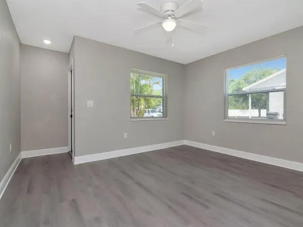 a view of an empty room with wooden floor