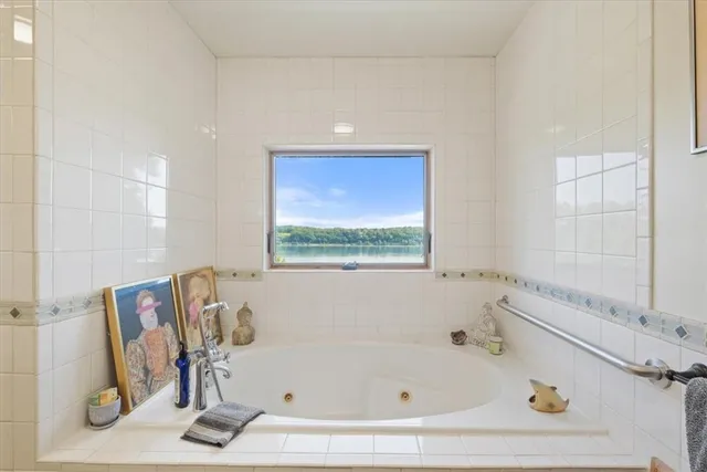 a bathroom with a tub and a window