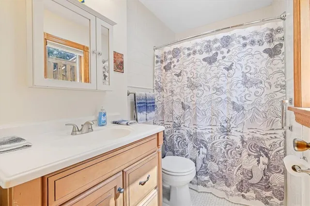 a bathroom with a sink toilet and a mirror