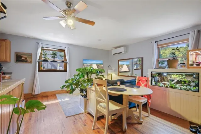 a view of a dining room with furniture window and wooden floor
