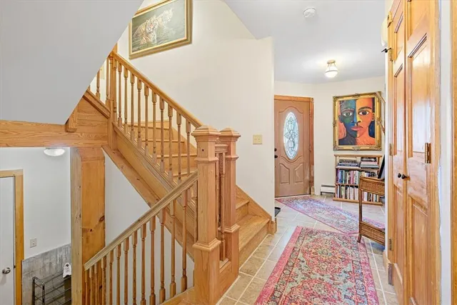 a view of an entryway with wooden floor and windows