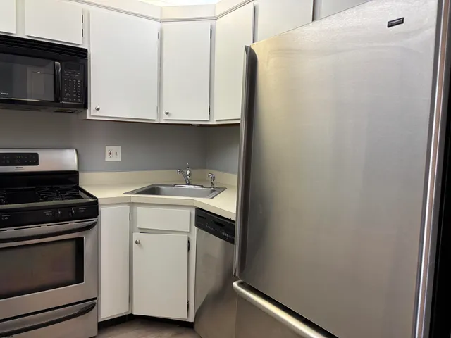 a kitchen with a sink and a stove top oven