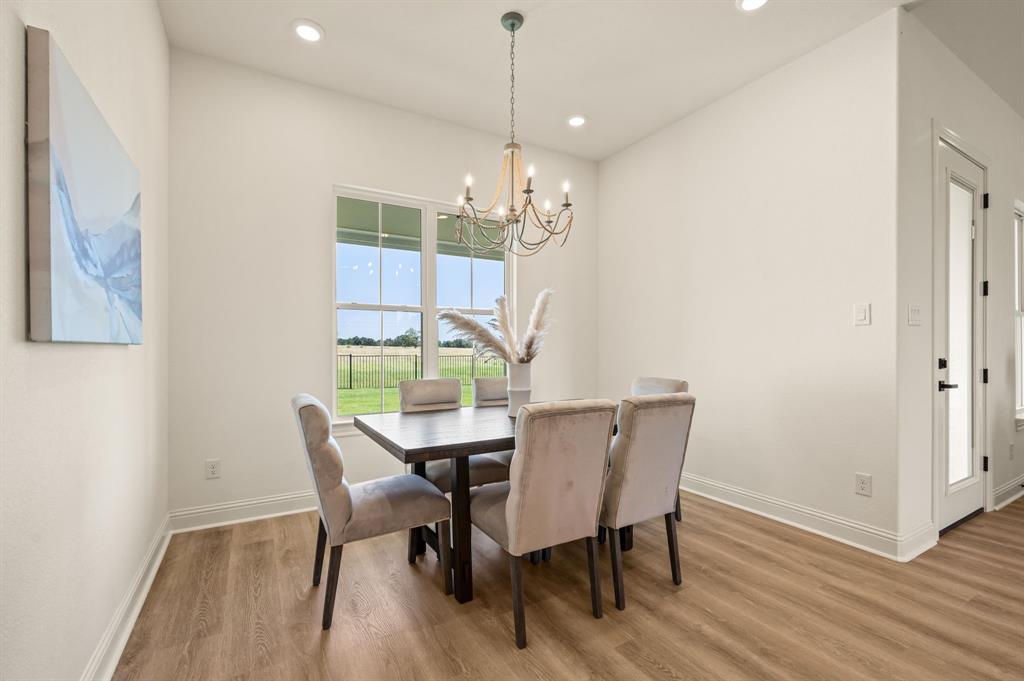2705 Gospel Road Tolar, TX 76476 - Photo 15 of 36 Dining area featuring luxury vinyl flooring, a large window with exterior views, and recessed lighting