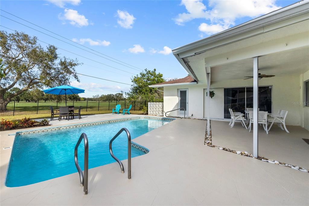 433 Whitfield Avenue Sarasota, FL 34243 - Photo 13 of 46 a swimming pool with outdoor seating and yard