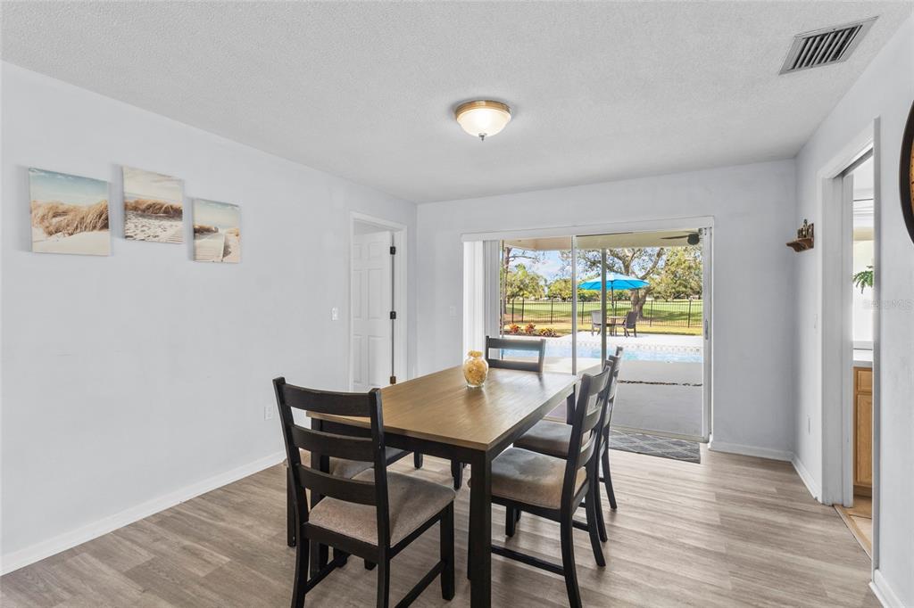 433 Whitfield Avenue Sarasota, FL 34243 - Photo 15 of 46 a view of a dining room with furniture window and wooden floor