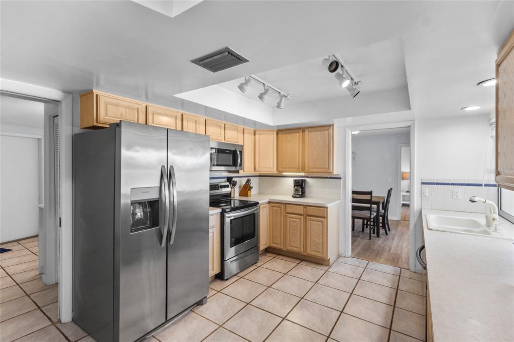 433 Whitfield Avenue Sarasota, FL 34243 - Photo 17 of 46 a kitchen with stainless steel appliances granite countertop a refrigerator and a stove top oven
