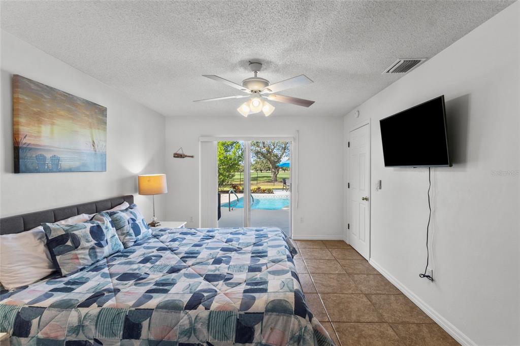 433 Whitfield Avenue Sarasota, FL 34243 - Photo 22 of 46 a bedroom with a bed and a flat screen tv