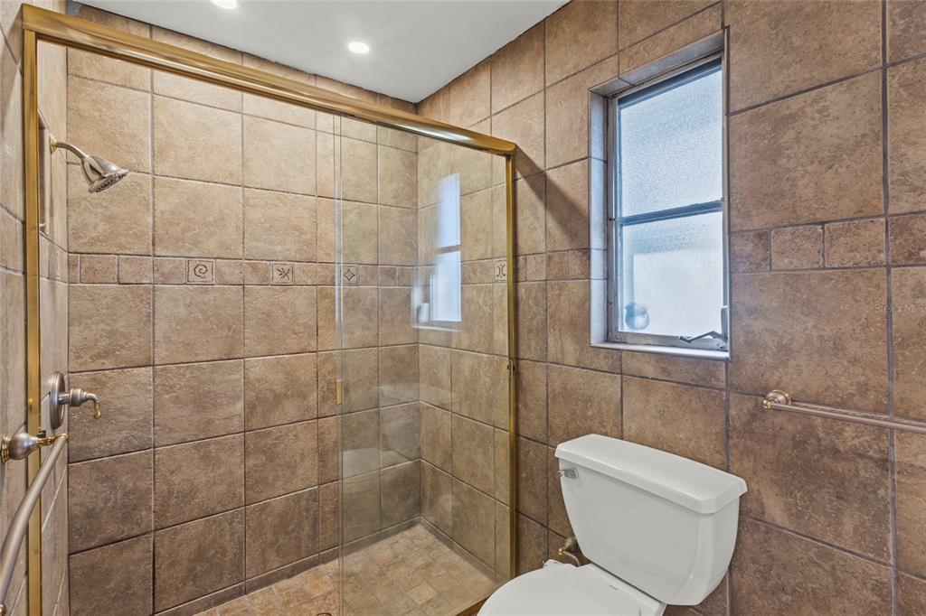 433 Whitfield Avenue Sarasota, FL 34243 - Photo 25 of 46 a bathroom with a toilet and a shower