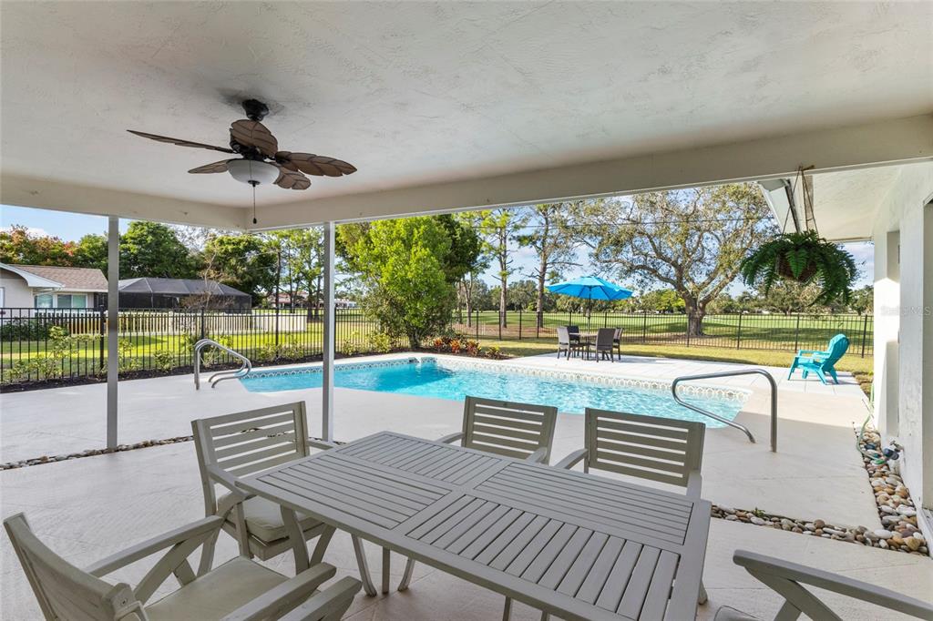 433 Whitfield Avenue Sarasota, FL 34243 - Photo 8 of 46 a view of a patio with a table chairs and a swimming pool