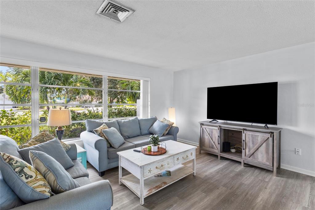 433 Whitfield Avenue Sarasota, FL 34243 - Photo 10 of 46 a living room with furniture and a flat screen tv