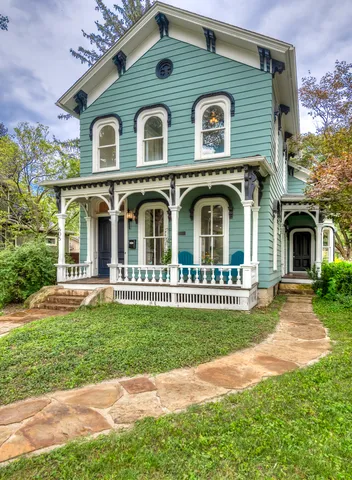 a front view of a house with a garden