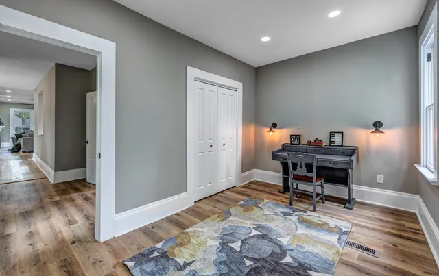 a workspace with furniture and wooden floor