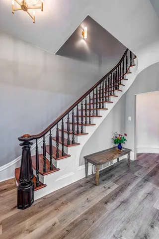 a view of entryway and hall with wooden floor