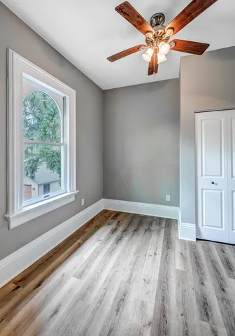wooden floor in an empty room with a window