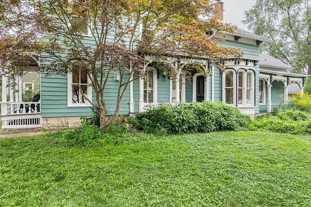 a front view of a house with a garden