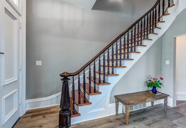 a view of entryway with wooden floor and stairs