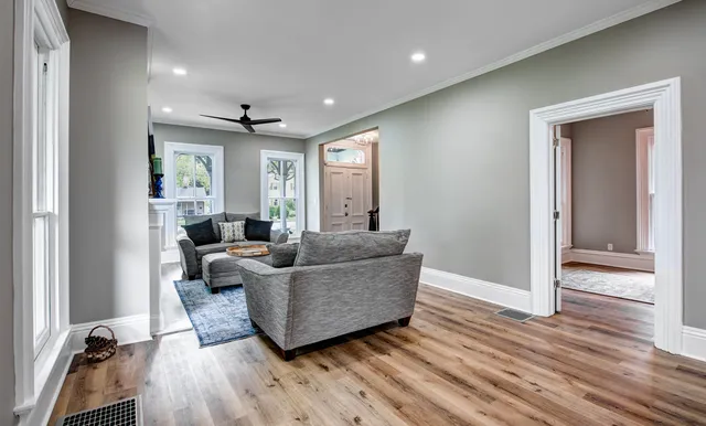 a living room with furniture and a wooden floor
