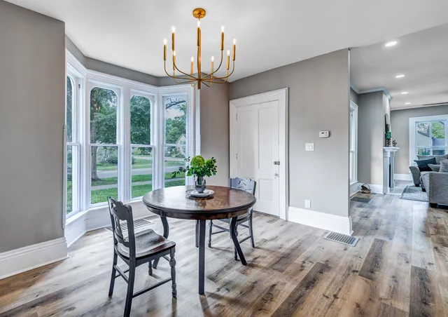 a view of a dining room with furniture window and wooden floor