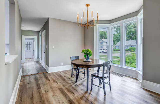 a view of a dining room with furniture window and wooden floor