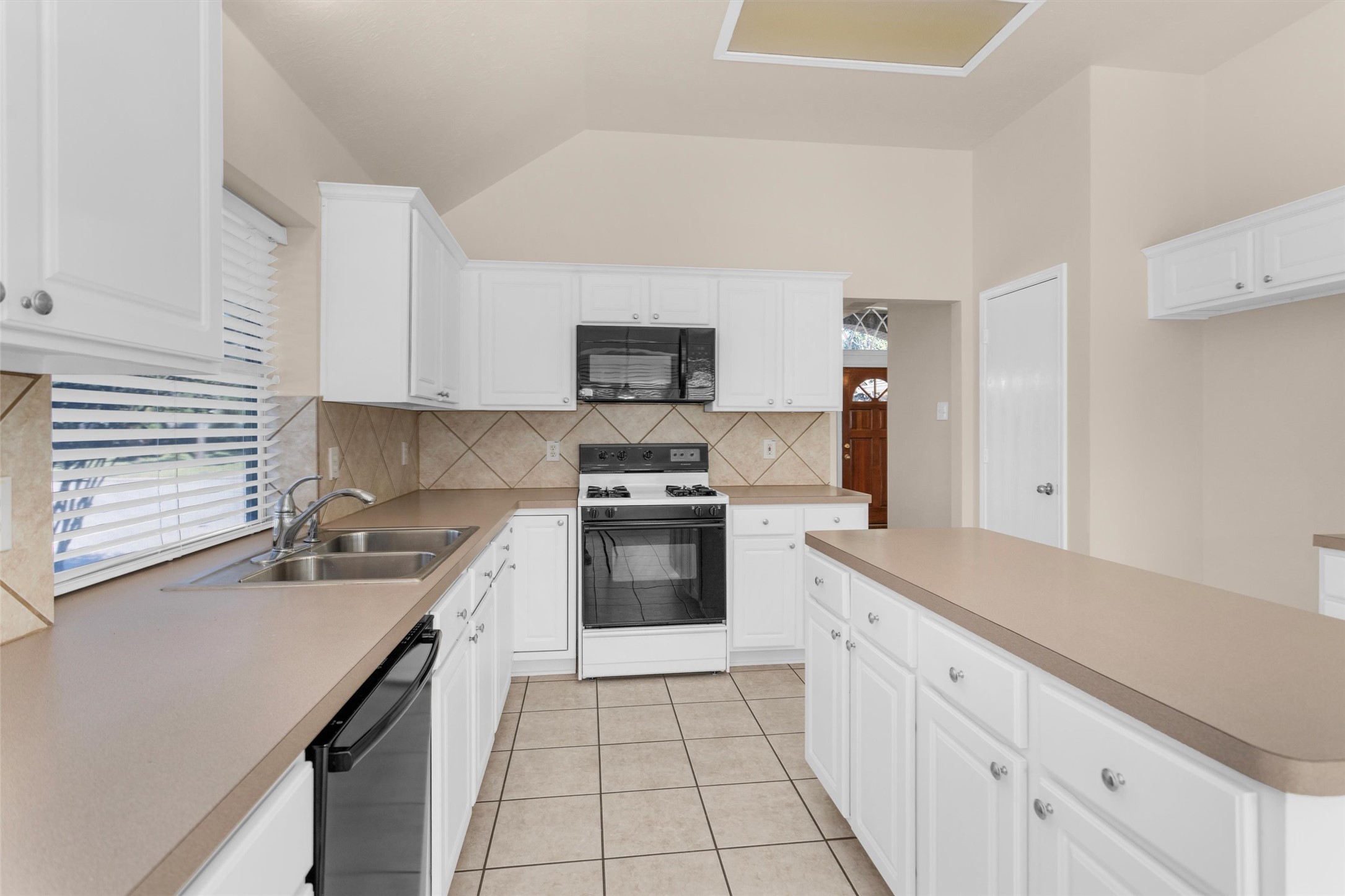 2615 Honeysuckle Walk Spring, TX 77388 - Photo 17 of 39 a kitchen with granite countertop a sink a stove top oven and cabinetry