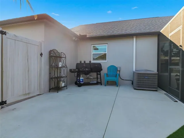 a view of a patio with table and chairs under an umbrella