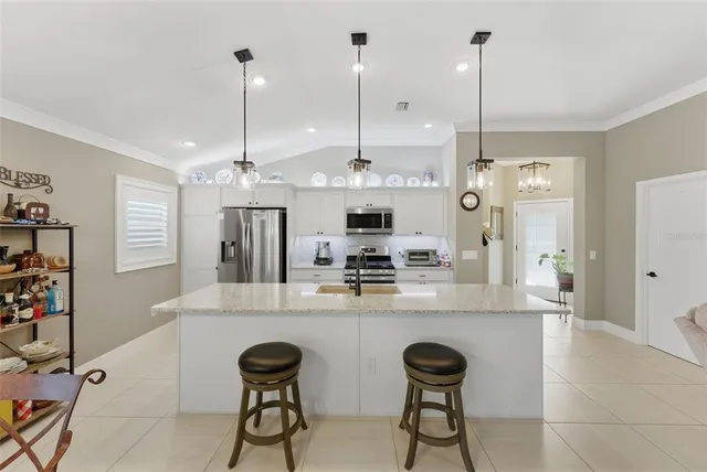 a view of a patio with a table and chairs under an umbrella