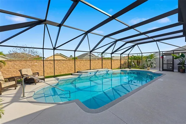 a kitchen with stainless steel appliances granite countertop a refrigerator a stove a sink and a microwave