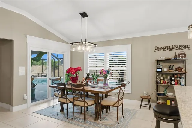 a living room with patio furniture and a floor to ceiling window