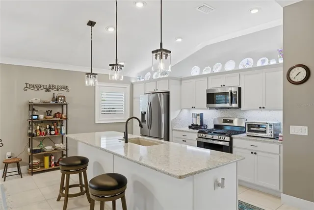 a kitchen with refrigerator and cabinets