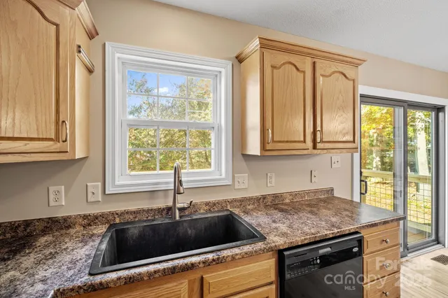 a kitchen with granite countertop a sink and a window